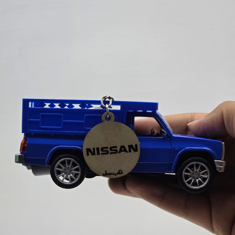 ماشین بازی غیرکنترلی ناب سل مدل NISSAN طرح وانت فانتزی، دودزا، چراغدار و موزیکال فلزی به همراه جاسوییچی